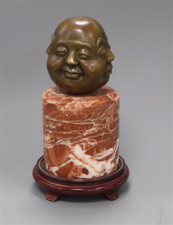 An Eastern bronze four mask Buddhistic head, on marble socle height 28cm. incl. wood stand